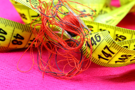 tailoring supplies and sewing accessories on fabric background
