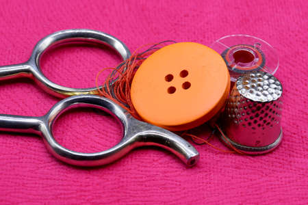 tailoring supplies and sewing accessories on fabric backgroundの写真素材