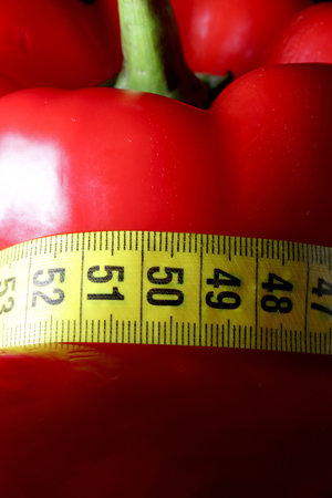 colored measuring tape colored red bell on black backgroundの写真素材