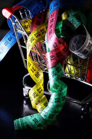 colored measuring tape on a black backgroundの写真素材