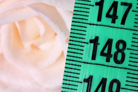 diet concept with measuring tape and white roseの写真素材