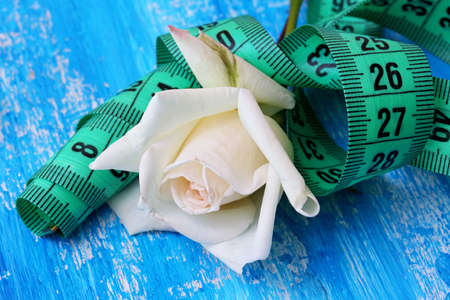 diet concept with measuring tape and white roseの写真素材