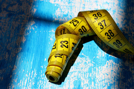 measuring tape on blue background