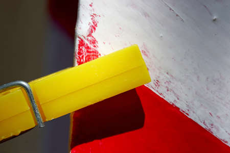 yellow pegs hanging on a wallの写真素材