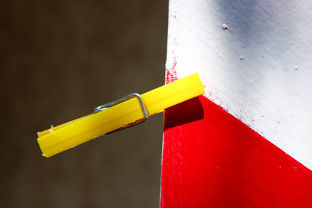 yellow pegs hanging on a wall