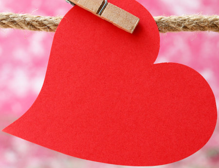 red paper hearts hanging on clotheslineの写真素材