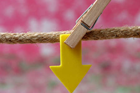 direction sign hanging on clotheslineの写真素材