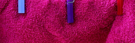 red towel hanging on a clotheslineの写真素材