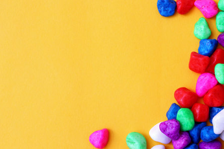 colored pebbles on yellow background