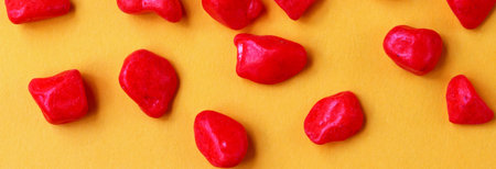 red pebbles on yellow background
