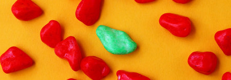 red and green pebbles on yellow background