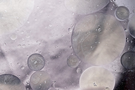 macro photo of water droplets in oil with a colorful abstract background
