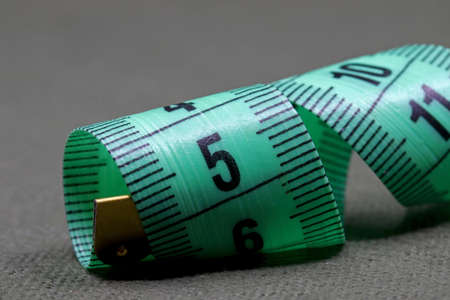 green measuring tape on fabric backgroundの写真素材
