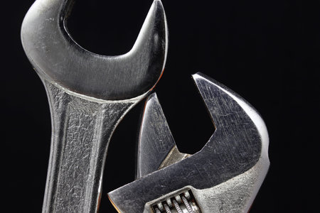 detail of close-up wrench on black background