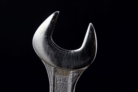 detail of close-up wrench on black background