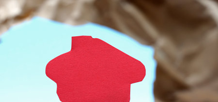 paper house shape on blue background