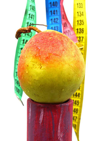 diet concept with measuring tape and a pear in the backgroundの写真素材