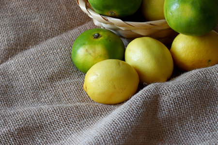 lemons and tangerines in a wicker basketの写真素材