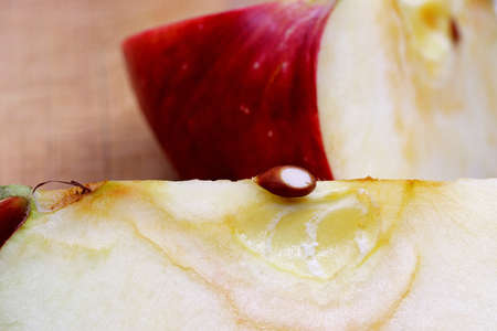 sliced red apple on a chopping boardの写真素材