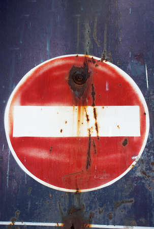 dirty red and white no parking signの写真素材