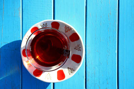 glass of Turkish tea on wooden tableの写真素材