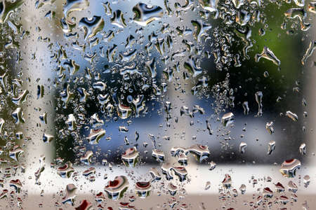 water drops on glass colorful backgroundの写真素材