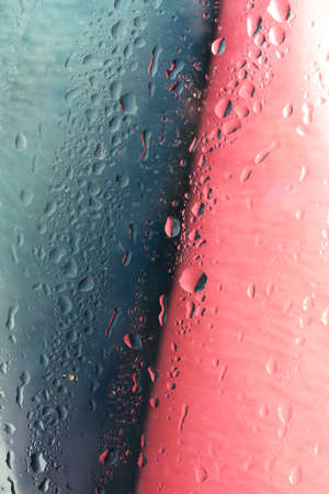 water drops on glass colorful backgroundの写真素材