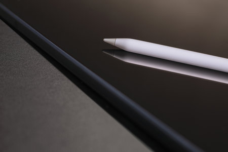 Close-up of digital tablet and stylus pen on black backgroundの写真素材