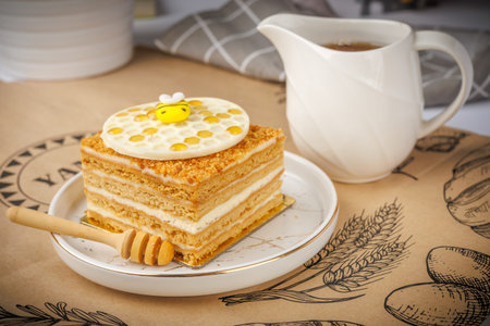Napoleon cake with honey and cup of coffee on the table.