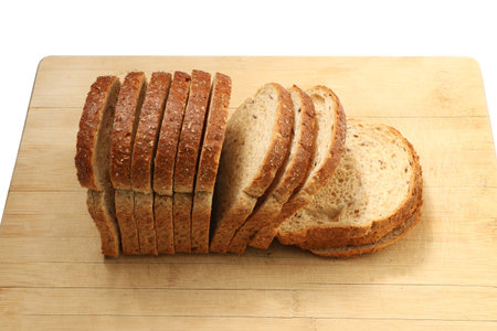toast bread slices on wooden board - isolated on white background