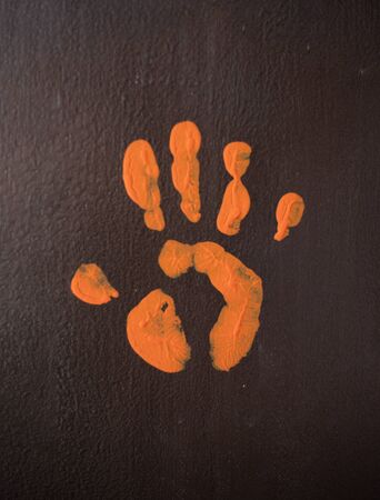 An orange palm print on a brown wallの写真素材