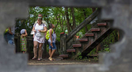 Nha Trang, Vietnam-November 2, 2017: People at the foot of the stairs leading to the Long Shon Pagoda. Shot through a hole in the fenceのeditorial素材