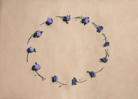 Oval flower arrangement. Fresh flax flowers on a pastel beige background. Summer concept. Flat sunbed, top view, copy spaceの写真素材