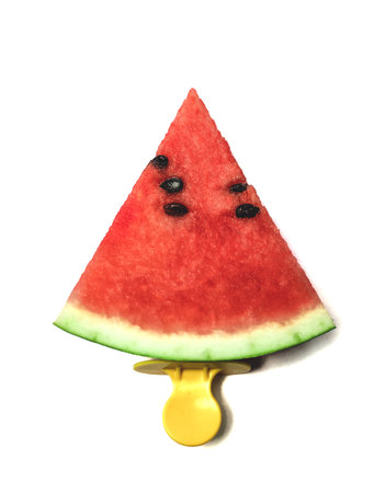 Slice of watermelon on an ice cream stick on a white isolated background. Creative idea top view