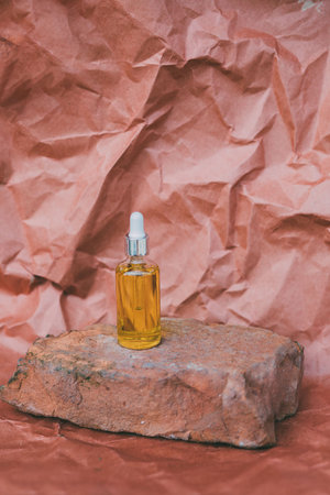 Glass bottle and dropper OIL on old brick with pastel background. Laboratory Production of cosmetics...
