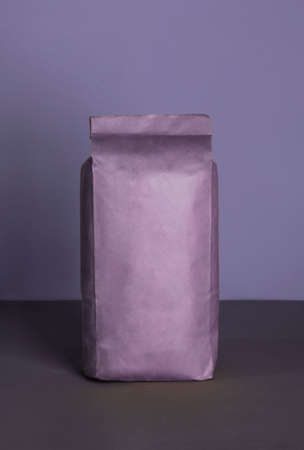 Small blank bulky purple package with product on a purple-lilac background . Ready for shipping, delivery and sale. Small business artisan concept.の写真素材