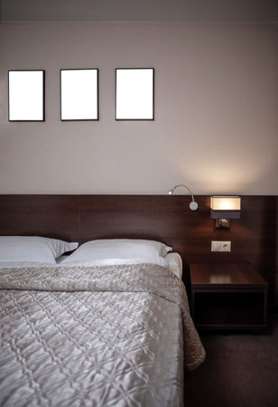 Interior of a comfortable hotel bedroom in the morning in luxury style. Big window. Black wooden...