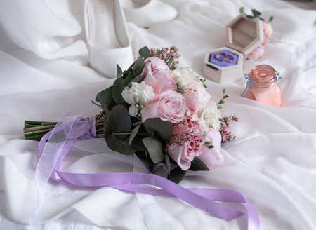 Picture of bridal bouquet. Married couple ceremony wedding day. Newly wed couples hands with wedding rings.の写真素材