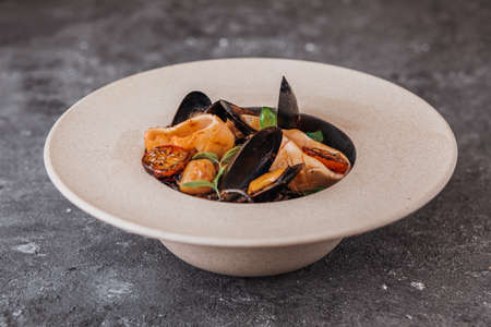 Black spaghetti pasta with black squid ink and seafood in pepper sauce and parmesan.の写真素材