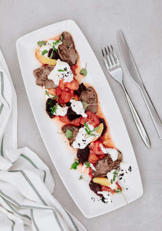 fillet and fresh vegetable salad of lettuce, arugula, spinach, cucumber and tomato. Healthy lunch menu. Diet food.の写真素材