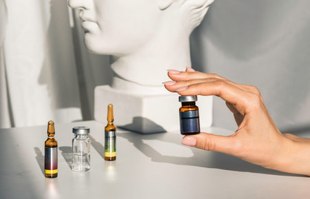 cosmetic injection. beautician prepares to put injection in face. Cosmetic injection of in the...