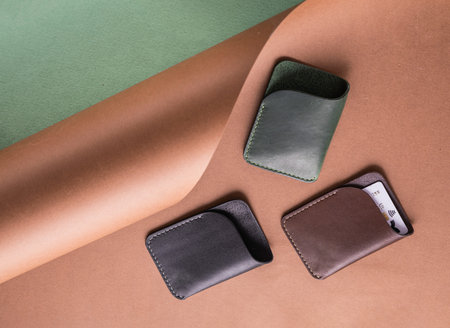 Leather card holders Mock up. Set of different color cardholders on paper background