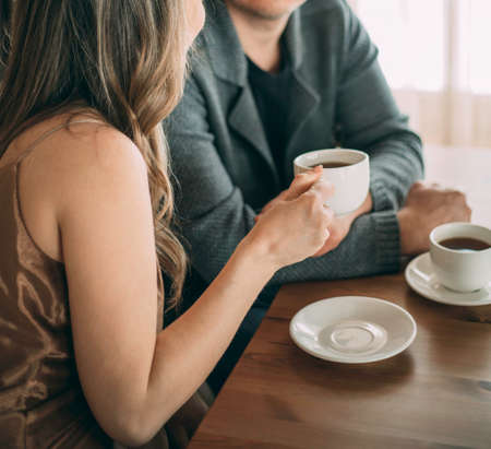 Closeup image of a man and a woman white coffee mugsの写真素材