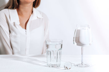 Casual style young woman with water glasses. Female model