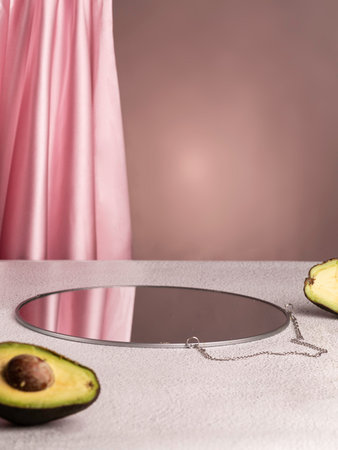 Showcase mock up for perfume advertising, cosmetics stand, branding scene with avocado. Pink...