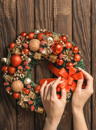 Woman makes a fir wreath for advent. Christmas Eve and Decorating. New Yearの写真素材