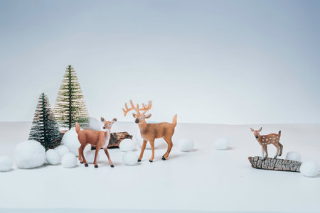Christmas winter festive composition. Colorful Xmas background, big and small deers, trees. Happy New Yearの写真素材