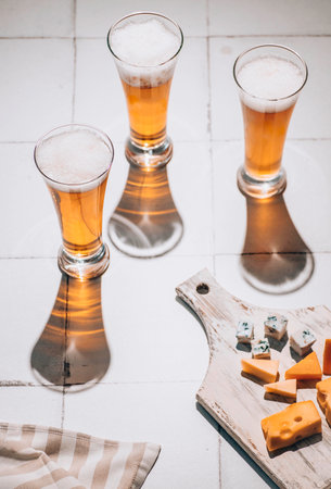 Beer and cheese. Glass of beer with cheese. Ale and food conceptの写真素材