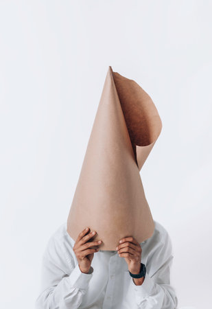 Cone of craft paper on the head. Futuristic Christmas concept.Sustainable Christmas, zero waste,...