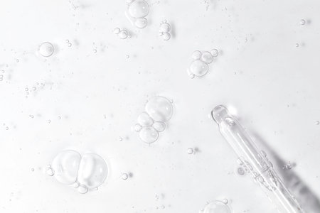 Cosmetic serum texture with dropper transparent liquid backgroundの写真素材